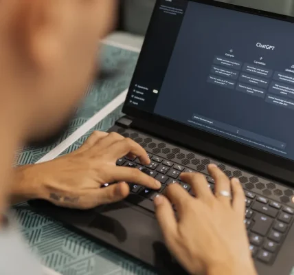 person typing on a laptop with an AI chat interface
