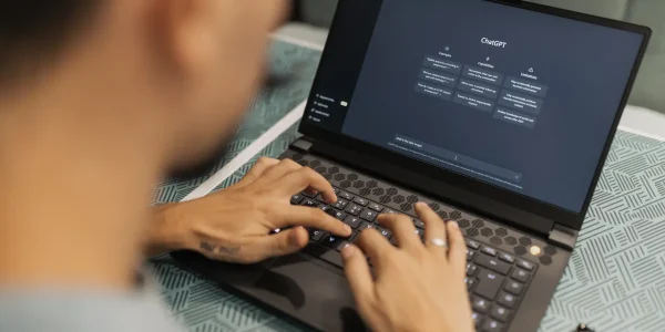 person typing on a laptop with an AI chat interface