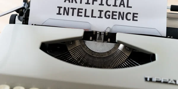 Typewriter with paper labeled artificial intelligence